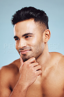 Buy stock photo Hand, face and beauty with a man model in studio on a blue background to promote grooming or skincare with an idea. Thinking, cosmetics and wellness with a handsome young male posing for luxury care