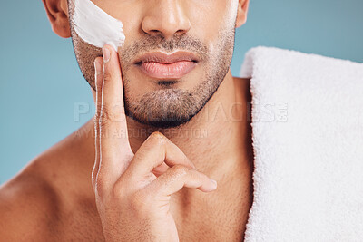 Buy stock photo Skincare, facial cream and hands of man using lotion, face cream and skincare product for shaving. Beauty, healthy skin and male apply moisturizer, foam and product to shave on blue background studio