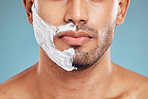 Face, shaving and beauty cream man closeup of beard facial, wellness and grooming product advertising. Cosmetic, skincare and shave foam hygiene routine of male model with teal studio background.

