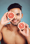 Skincare, grapefruit and health of man in studio for vitamin c, dermatology and wellness during after facial detox with natural fruit. Portrait of male India model happy about healthcare and skin