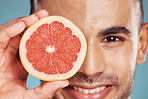 Skincare in nature, beauty and man with grapefruit slice for vitamin c facial detox for healthcare, natural healthy skin and smile. Fruit, wellness and sustainability, luxury 
cleaning and grooming.