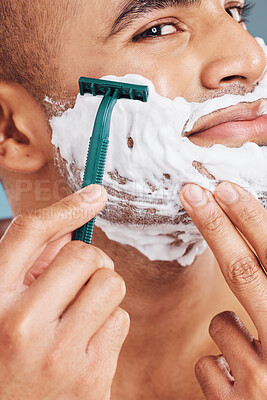 Buy stock photo Shaver, foam and man shaving his beard for hygiene, health and smooth skin in a studio. Razor, clean and handsome guy from India grooming his facial hair for dermatology wellness or a face treatment.