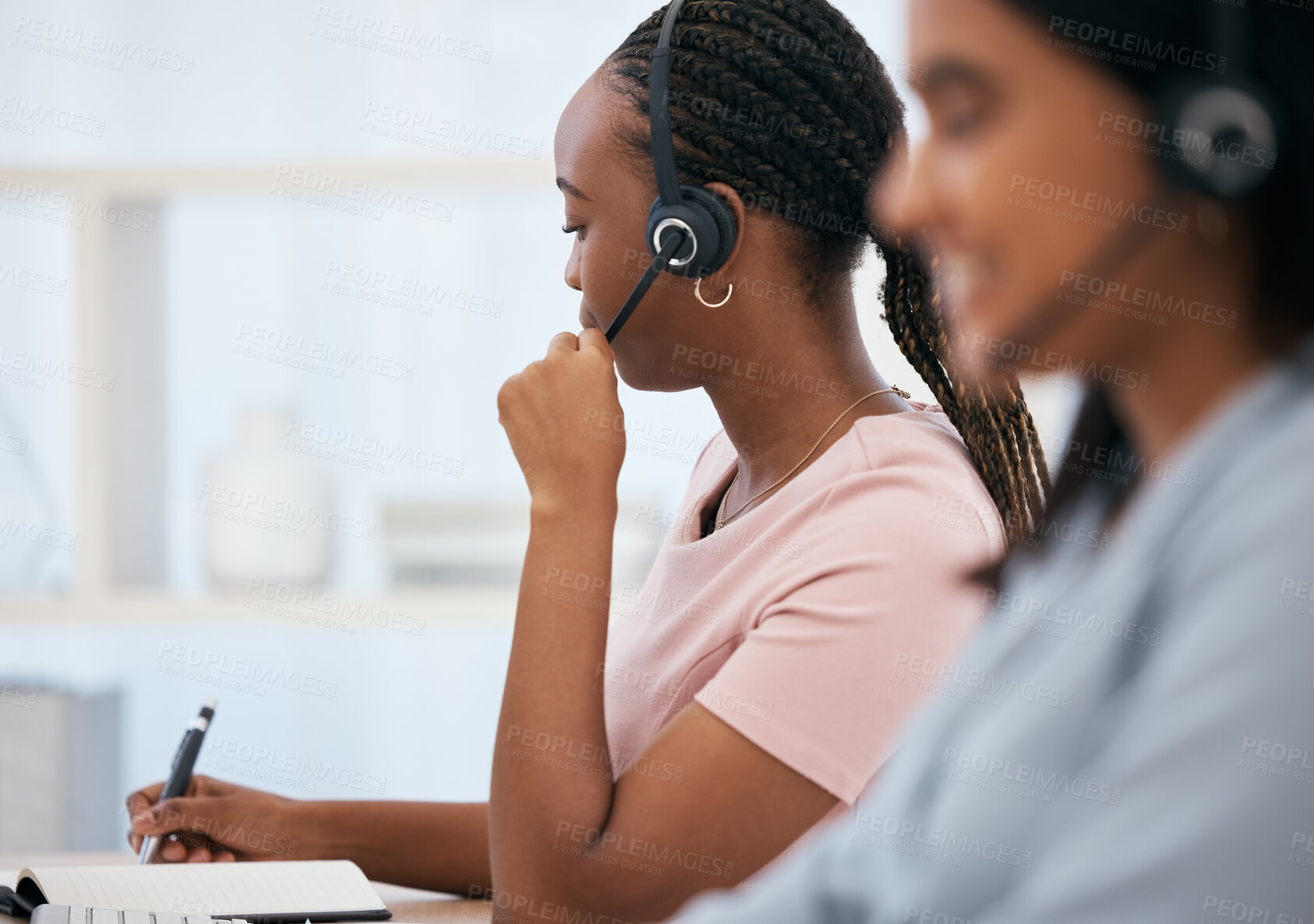 Buy stock photo Black woman, notebook writing or headset in call center, contact us or crm consulting office in telemarketing help. Receptionist, consultant agent or customer support workers in communication company