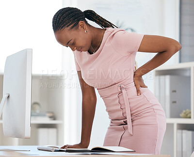 Buy stock photo Back pain, bad posture and strain with a black woman in business suffering while working at her desk in the office. Anatomy, spine and cramp with a female employee struggling with backache at work