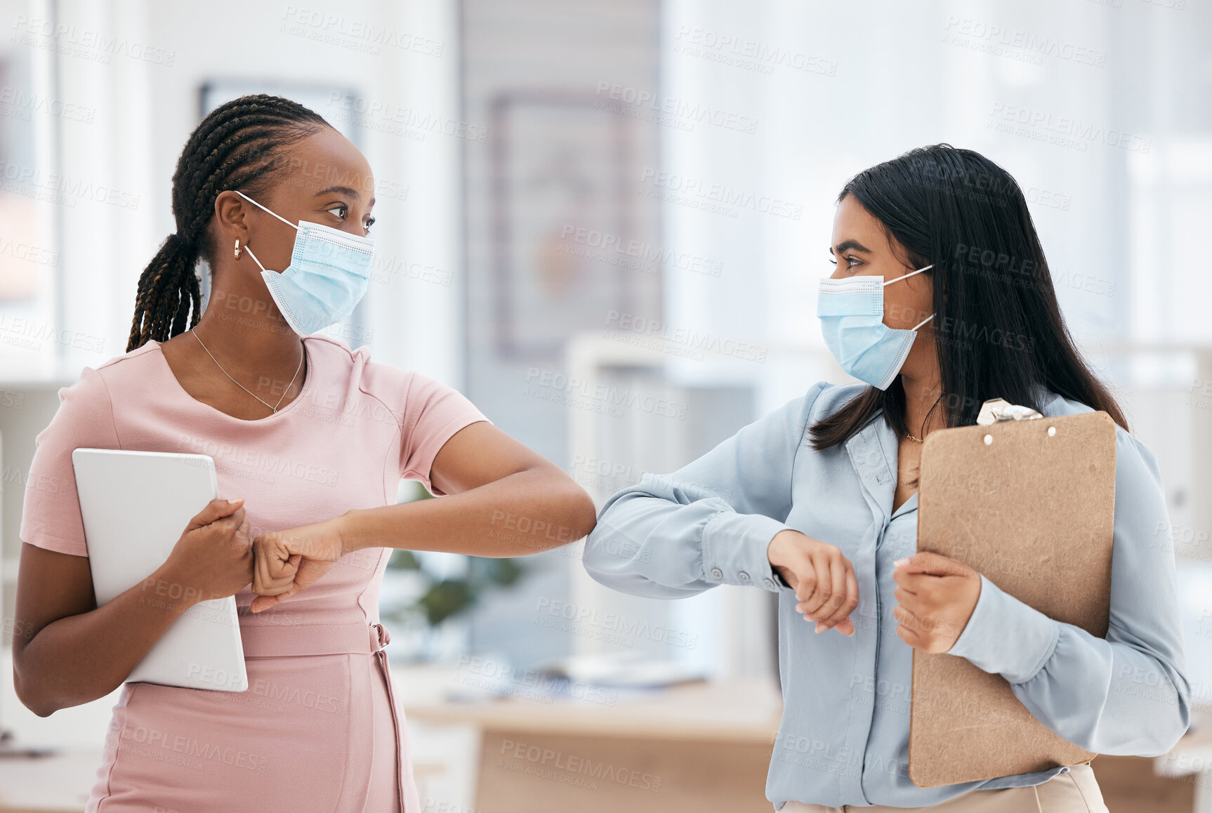 Buy stock photo Covid, greeting and teamwork with a business woman and colleague in business working together in their office. Collaboration, diversity and mask with an employee team during the corona virus pandemic