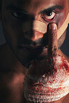 Fight, blood and face of boxing man with first aid bandage after sports competition, crime conflict or violence. Training, fighting injury and shadow portrait of mma boxer with middle finger gesture