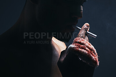 Buy stock photo Injury, cigarette and blood bandage on hand of kickboxing man in studio for shadow, art deco and bad habits background. Male champion boxer smoking after fighting in MMA violence sports competition