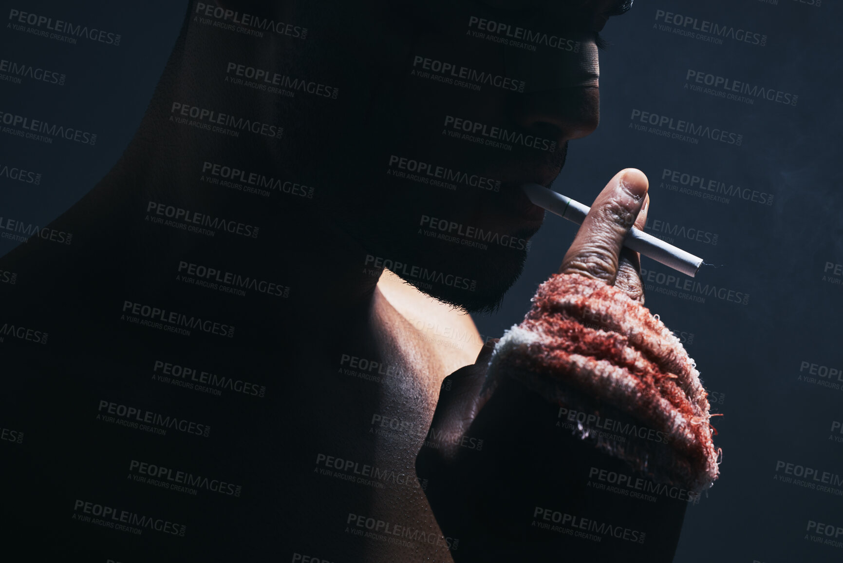 Buy stock photo Injury, cigarette and blood bandage on hand of kickboxing man in studio for shadow, art deco and bad habits background. Male champion boxer smoking after fighting in MMA violence sports competition