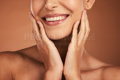 Buy stock photo Dental, smile and teeth, oral care and woman on brown studio background. Health, wellness and closeup of female model with hands on face showing her natural looking veneers, healthy mouth and lips

