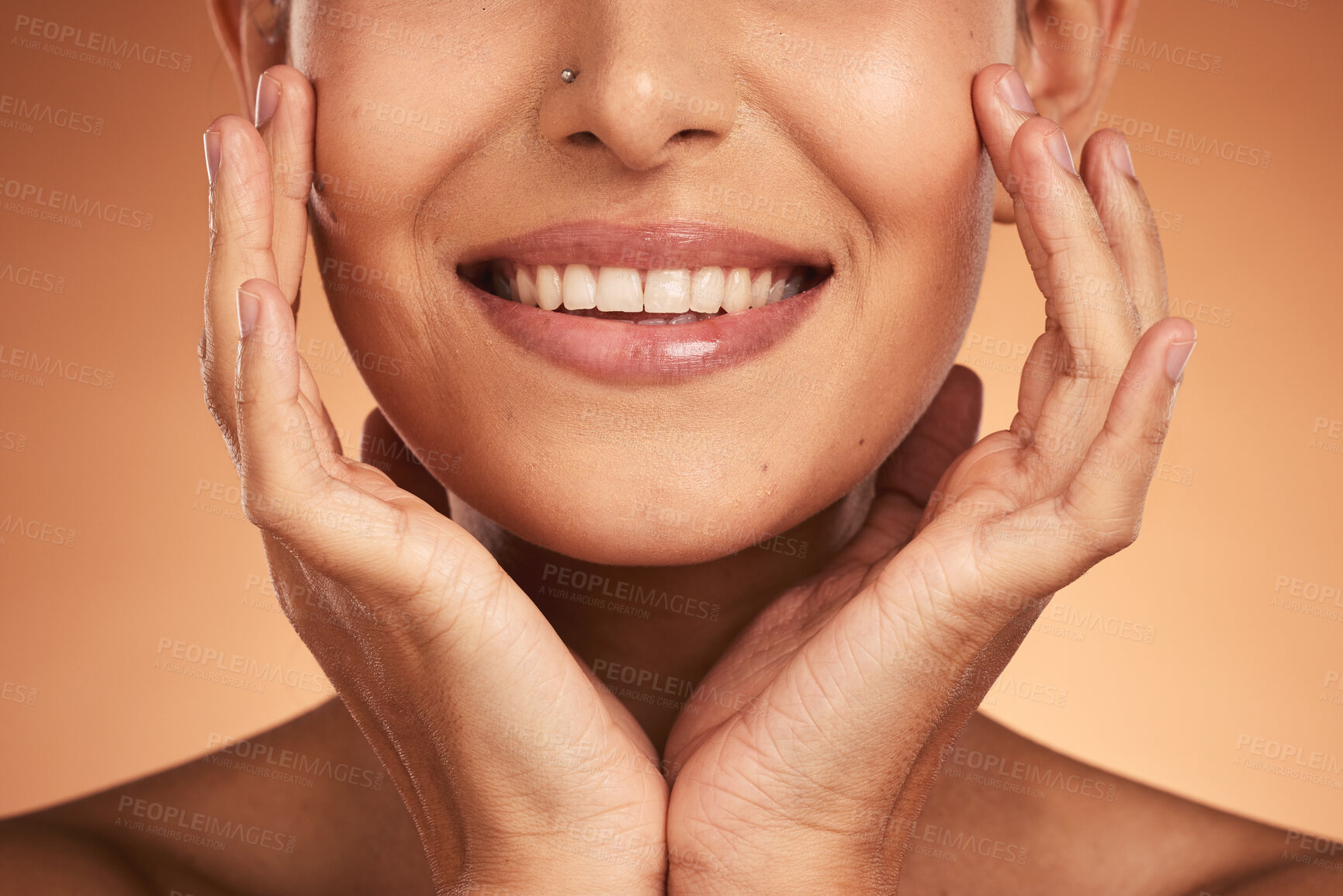 Buy stock photo Hands, mouth and beauty with a model woman in studio on a beige background to promote wellness with a smile. Cosmetics, skincare and happy with a female posing to promote natural treatment or product