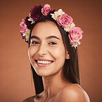 Woman, beauty smile and flower headband for spring portrait. Young happy girl, natural cosmetic makeup and healthy facial skincare wellness glow with floral rose band in orange background studio 