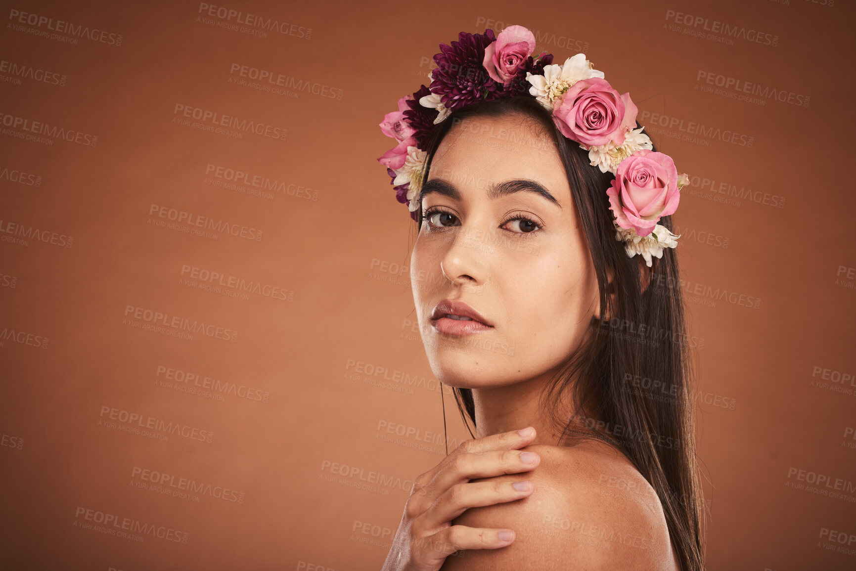 Buy stock photo Makeup, beauty and woman with floral crown on head to model for cosmetics, beauty products and fashion. Creative, hair and artistic portrait of girl with flower headband  on brown background studio