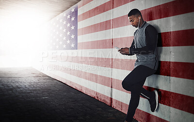 Buy stock photo Cropped shot of a handsome young man sending a text while exercising outside