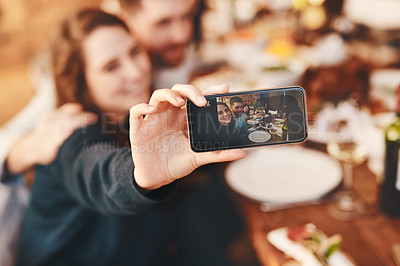 Buy stock photo Selfie, phone and couple at a dinner celebration with a memory of eating together. Food, social media and man and woman with a photo on a mobile during a Christmas or Thanksgiving lunch party