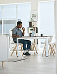 Black man, coffee drinking and office with laptop, table and thinking in marketing startup business. Man, drink espresso or tea at desk with computer, reading and planning for digital marketing job
