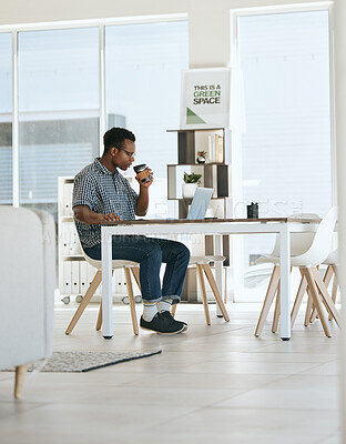 Black man, coffee drinking and office with laptop, table and thinking in marketing startup business. Man, drink espresso or tea at desk with computer, reading and planning for digital marketing job