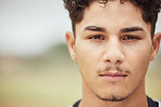 Man, face and serious facial expression of a person from Madrid with mock up in nature. Portrait of a young, student and male head feeling calm and relax outdoor with focus and mockup space