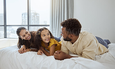 Buy stock photo Happy, relax and family on a bed bonding in the bedroom together of their modern home in Mexico. Happiness, smile and parents relaxing, talking and resting with their girl child at their house.