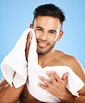 Towel, face and skincare of beauty man in studio for facial cleaning, healthy glow or cosmetics mock up advertising with portrait smile. Young model for men skin care wash routine on blue mockup 