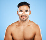 Beauty, skincare and eye patch with grooming and man in wellness for skin portrait against blue studio background. Eye care, healthy face and fresh glow with smile, clean with hygiene and cosmetic.