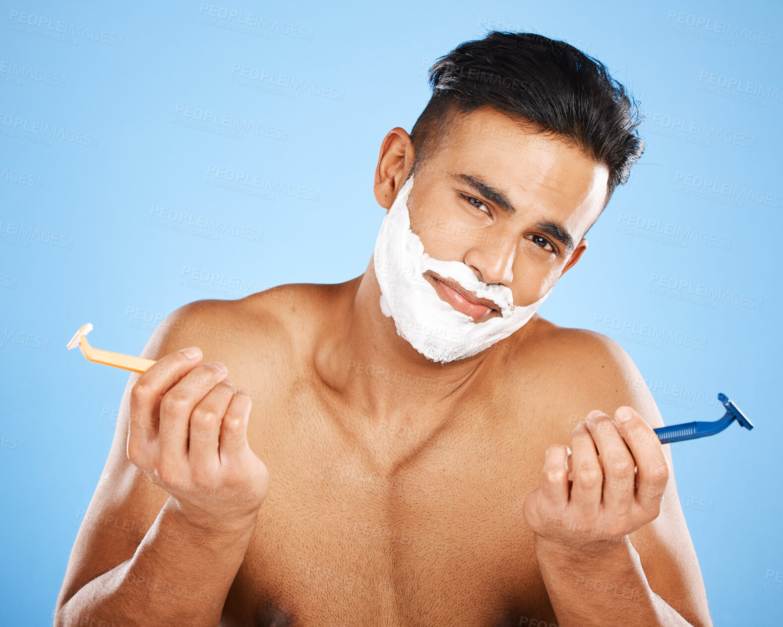 Buy stock photo Razor, choice and portrait of man with shaving cream making decision to shave beard in studio. Clean, hygiene and guy from India with doubt and shavers to groom face hair isolated by blue background.