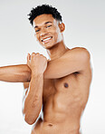Portrait, fitness and man in studio stretching his shoulder and arms for a body exercise, training and workout. Smile, healthy and happy fitness model getting ready to start exercising with a warm up