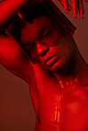 cyberpunk, man and red neon light studio for futuristic eyewear fashion aesthetic. Creative art design, vaporwave glasses and model face in graphic red background for future metaverse beauty portrait
