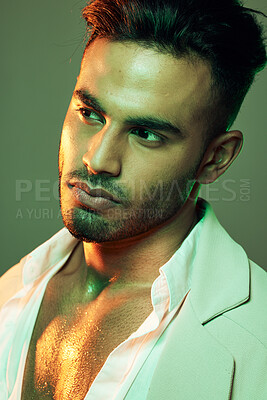 Buy stock photo Fashion, green light and man in studio isolated on a green background. Neon light, beauty and aesthetic of male model from India in designer jacket thinking, contemplating and posing in cool clothing