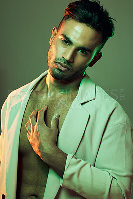 Buy stock photo Beauty, green lights and portrait of sexy man from India touching bare chest in creative studio shoot. Fashion, neon light and professional male model, single Indian man with seductive and sexy style