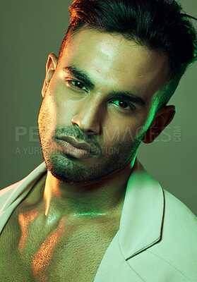Buy stock photo Fashion, green lights and portrait of sexy man from India in studio background creative shoot. Beauty, neon light and professional male model, Indian man and serious face in mens health and cosmetics