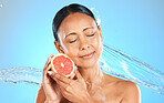 Water splash, fruit and skincare wellness of a woman with a grapefruit feeling health and beauty. Diet, nutrition and healthy skin of a model from Spain holding organic produce feeling calm and peace