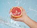 Grapefruit, fruit and water for health of body and skin with natural diet to lose weight or skincare with dermatology food. Hand holding vitamin c snack for a healthy lifestyle or female orgasm