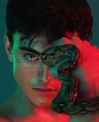 Buy stock photo Skincare, neon light and snake for skincare, danger and venom or poison for dermatology, power or aesthetic background. Portrait of model male in studio with python animal for beauty, art and fashion