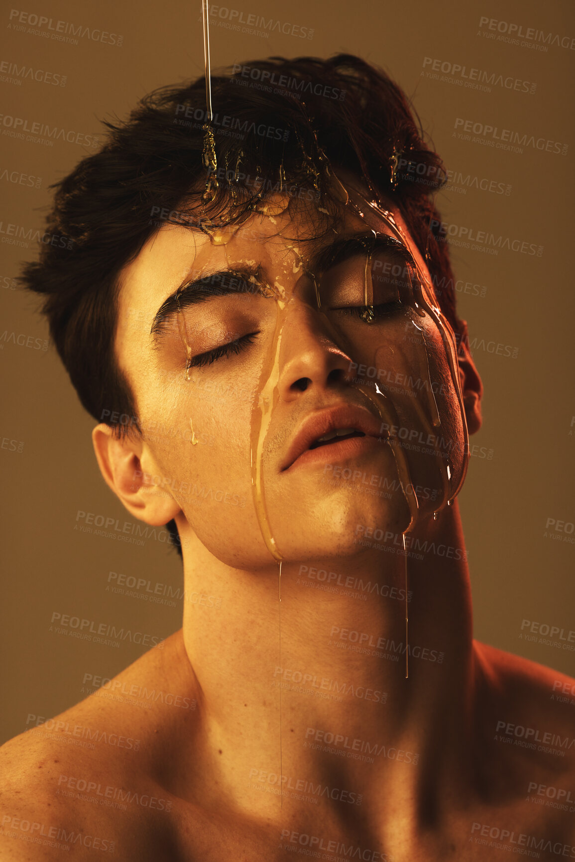 Buy stock photo Honey, facial and skincare of model in studio for beauty mask, dermatology and oil glow in creative headshot. Vegan, natural product on young man face for wellness, skin care and cosmetics aesthetic