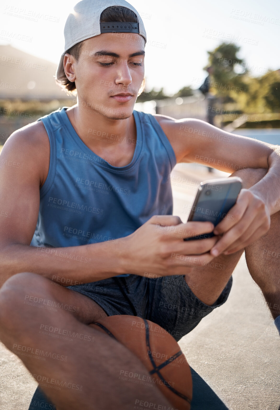 Buy stock photo Basketball, sports and man using phone for fitness mobile app, reading online website sport update or internet search for training tips. Healthy teen basketball player with smartphone 5g networking