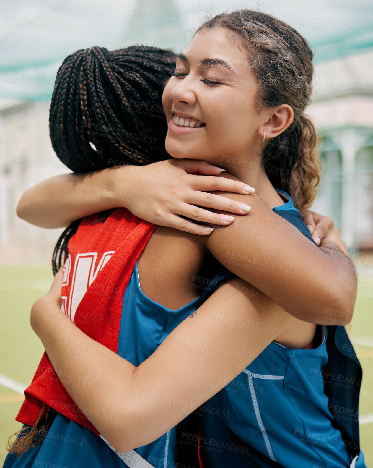 Buy stock photo Sport, hug and student girl game match showing support, trust and teamwork on a outdoor field. Student soccer or netball player with a happy smile show diversity and congratulations together