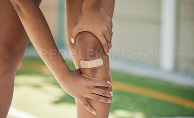 Buy stock photo Woman athlete, knee pain and sport injury outdoor with bandaid with inflammation, joint and strain accident. Girl holding leg, muscles tear and joint swelling or muscle fatigue in sports competition