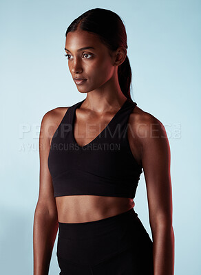 Buy stock photo Fitness, health and sports woman in studio for balance, form and motivation. Workout, health and beauty, athlete with goals and vision on blue background, beautiful healthy girl from India in profile