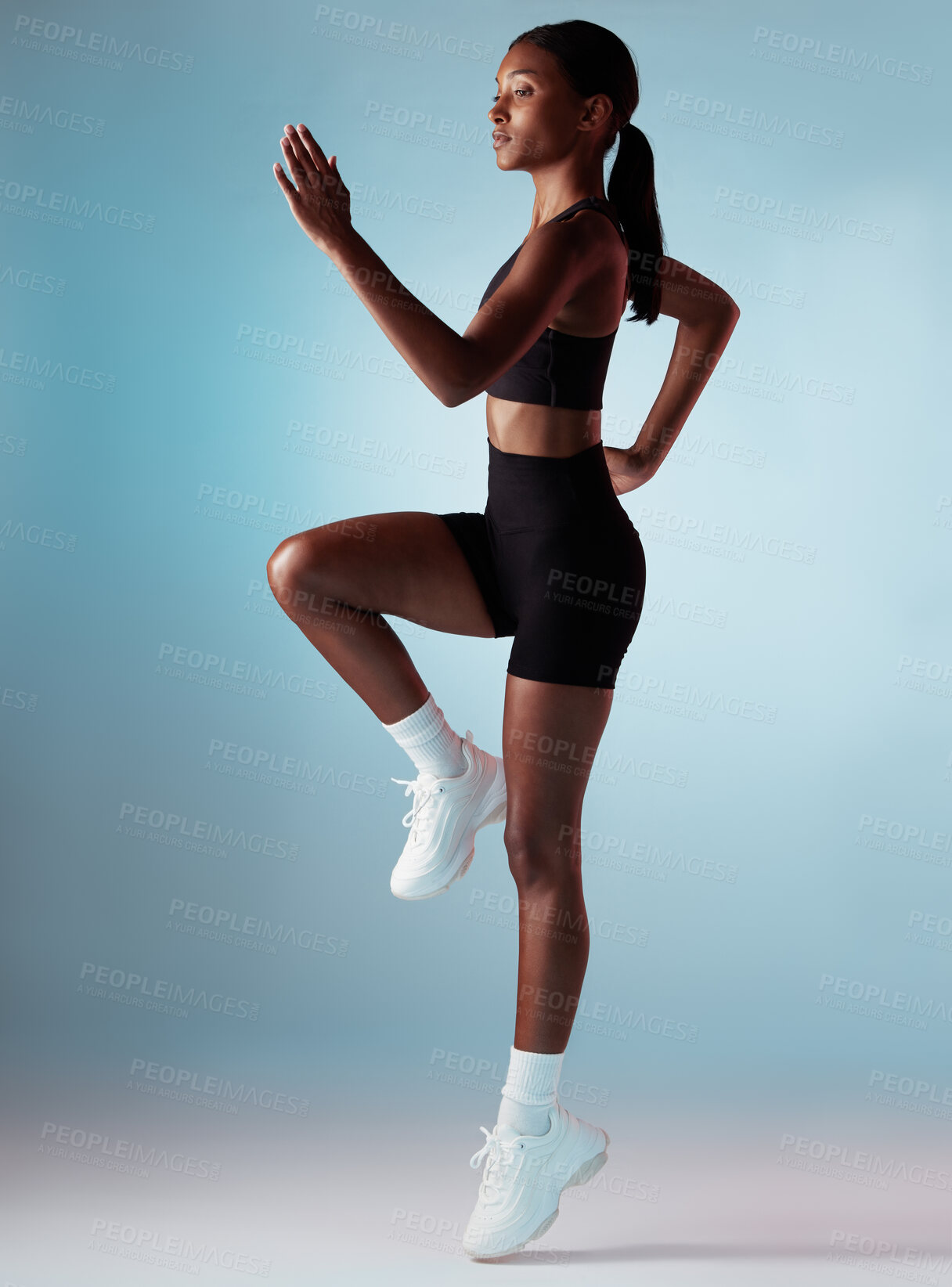 Buy stock photo Sports, exercise and woman runner in studio with balance, form and motivation. Fitness, health and black woman from Jamaica running on blue background. Healthy girl cardio training for marathon race.
