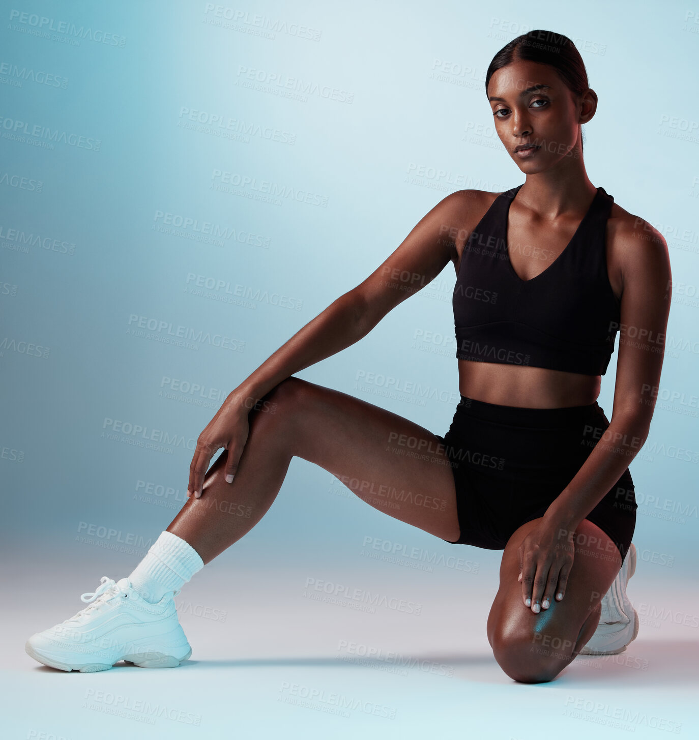 Buy stock photo Fitness, athlete and portrait of young woman in sportswear in a studio background for health. Wellness, active and focus with a fit, strong Indian woman posing in trendy sport clothing on backdrop. 