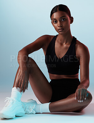 Woman, fitness or posing on blue background in studio in gym clothes with health goals, wellness mindset or sports target. Portrait, model or personal trainer with exercise, training and workout idea