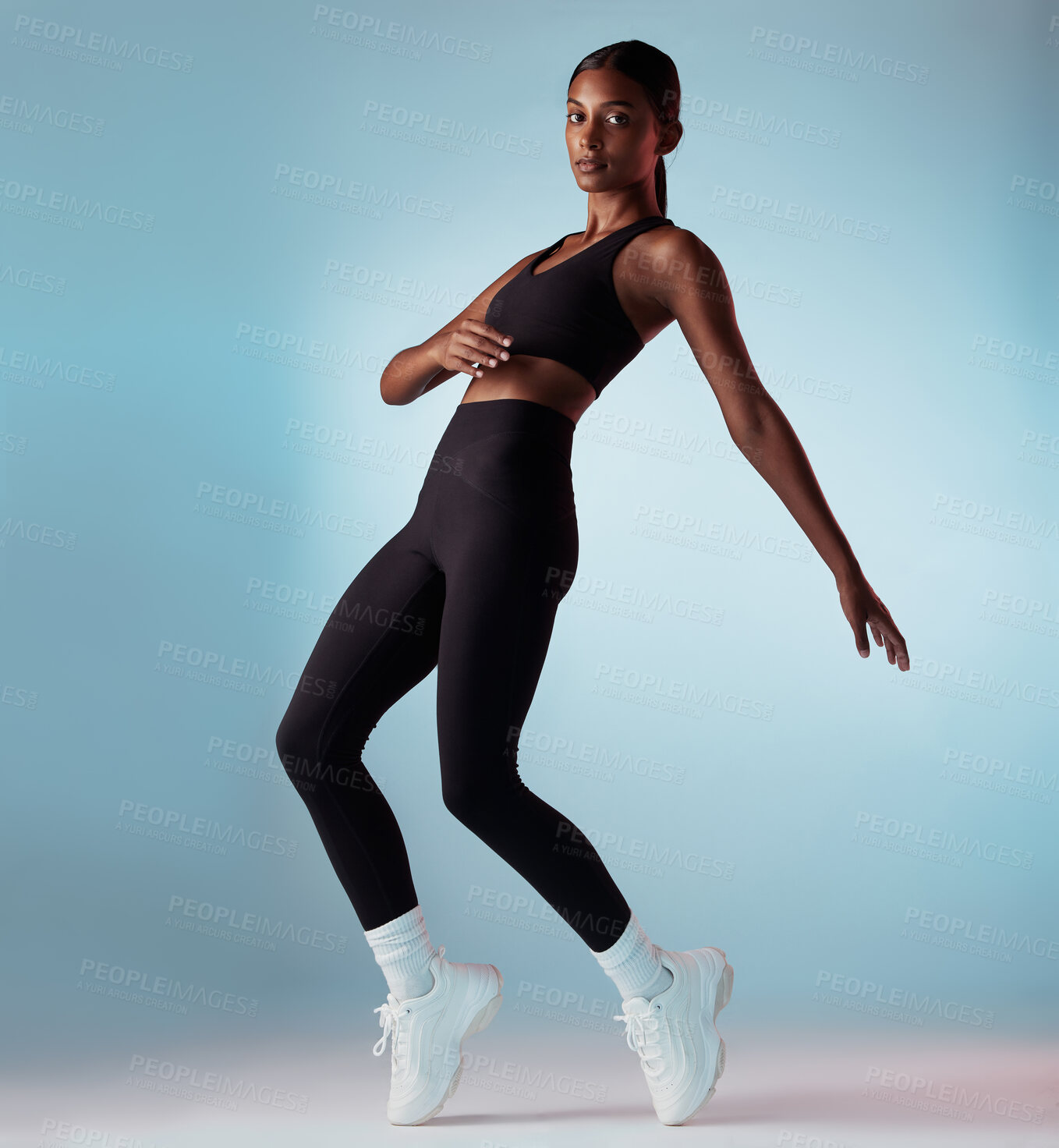 Buy stock photo Fitness, health and body black woman in studio portrait dancing for performance, workout and training marketing mock up. Sneakers, shoes or fashion model dancer balance on legs for an exercise dance