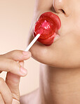 Lips, lipstick and lollipop, makeup and woman with face closeup in cosmetics advertising with studio background. Beauty, skin and cosmetics product marketing with candy, creative and color.