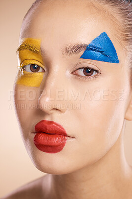 Buy stock photo Makeup, clown and face of a woman with color for creative, cosmetic and fantasy against a studio background. Halloween, circus and portrait of a model with facial paint for art and crazy creativity