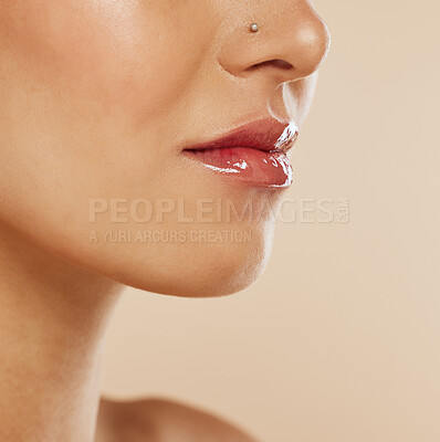 Buy stock photo Beauty, lips and mouth with lip gloss, lipstick and cosmetics makeup product for mockup skincare advertising on beige studio background. Dermatology, cosmetology and self care wellness of model skin 