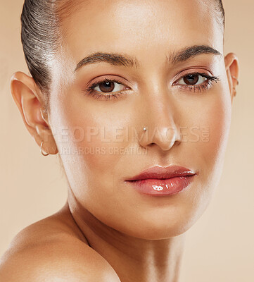 Buy stock photo Face, beauty and skincare with a model woman in studio on a beige background for natural care or treatment. Portrait, cosmetics and luxury with an attractive young female posing to promote a product