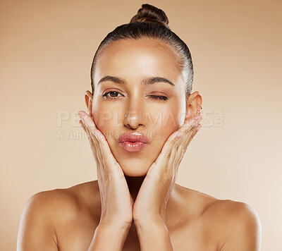 Buy stock photo Cosmetics, skincare and young woman face with natural beauty, pride or wellness with brown studio background. Portrait, makeup and girl touch cheeks, healthy or organic facial for smooth skin or glow