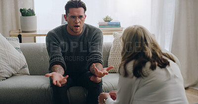 Buy stock photo Stress, anxiety and man talking to psychologist on sofa in mental health, anxiety or bipolar counselling therapy. Angry, explaining or crisis patient in psychology counseling communication with woman