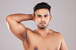 Man, beauty skincare and healthy cosmetic bodycare grooming. Portrait of young male flexing, facial and skin dermatology wellness lifestyle for mental health wellbeing in gray background studio