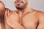 Beard, armpit and body skincare of man in studio isolated on a gray background. Hygiene, grooming and chest hair removal of muscular male fitness model, waxing and cleaning for wellness and beauty.